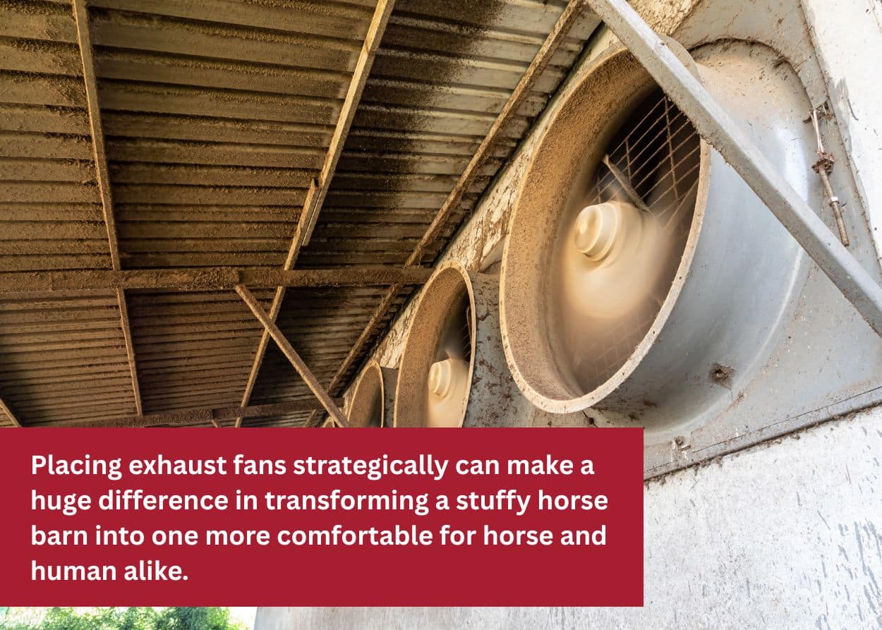 Large industrial exhaust fans mounted inside a barn for ventilation.