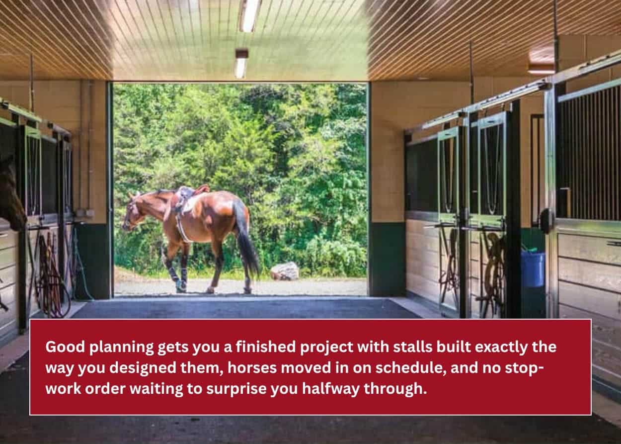 Horse standing outside a completed barn with custom stalls and a spacious center aisle.